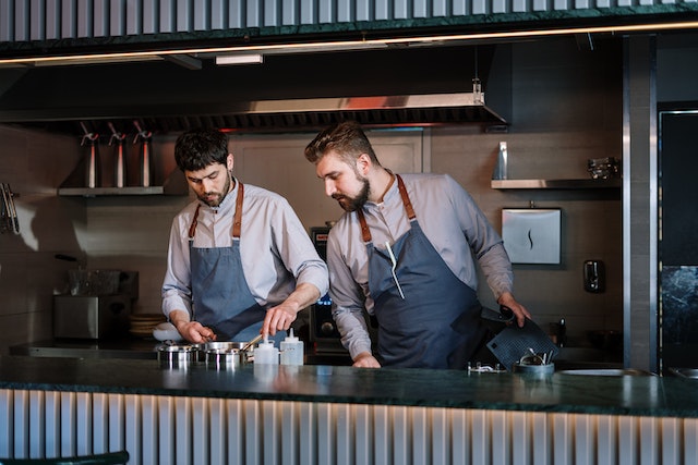 Two guys working in the kitchen